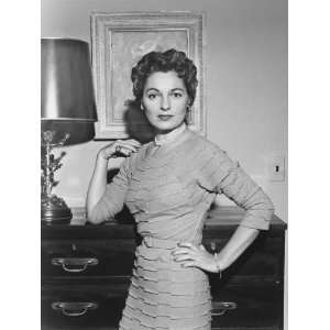  Woman Standing in Living Room With Hand on Cabinet 