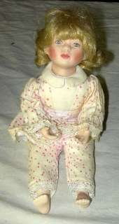   is a neat 1992 mbi artist signed porcelain girl doll the young girl